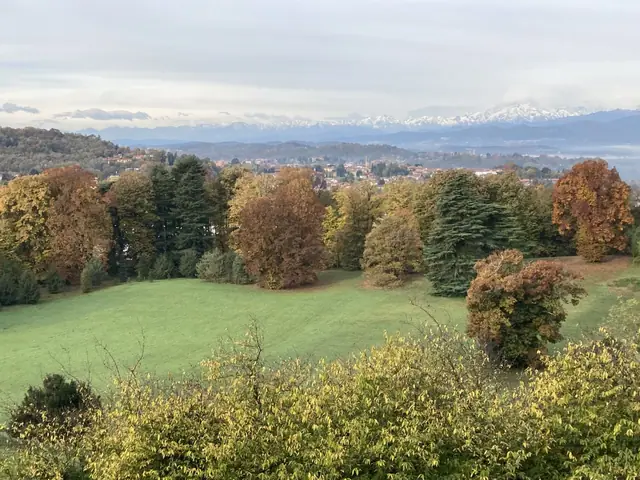 Il parco che scende verso la valle in autunno, con le Alpi all'orizzonte